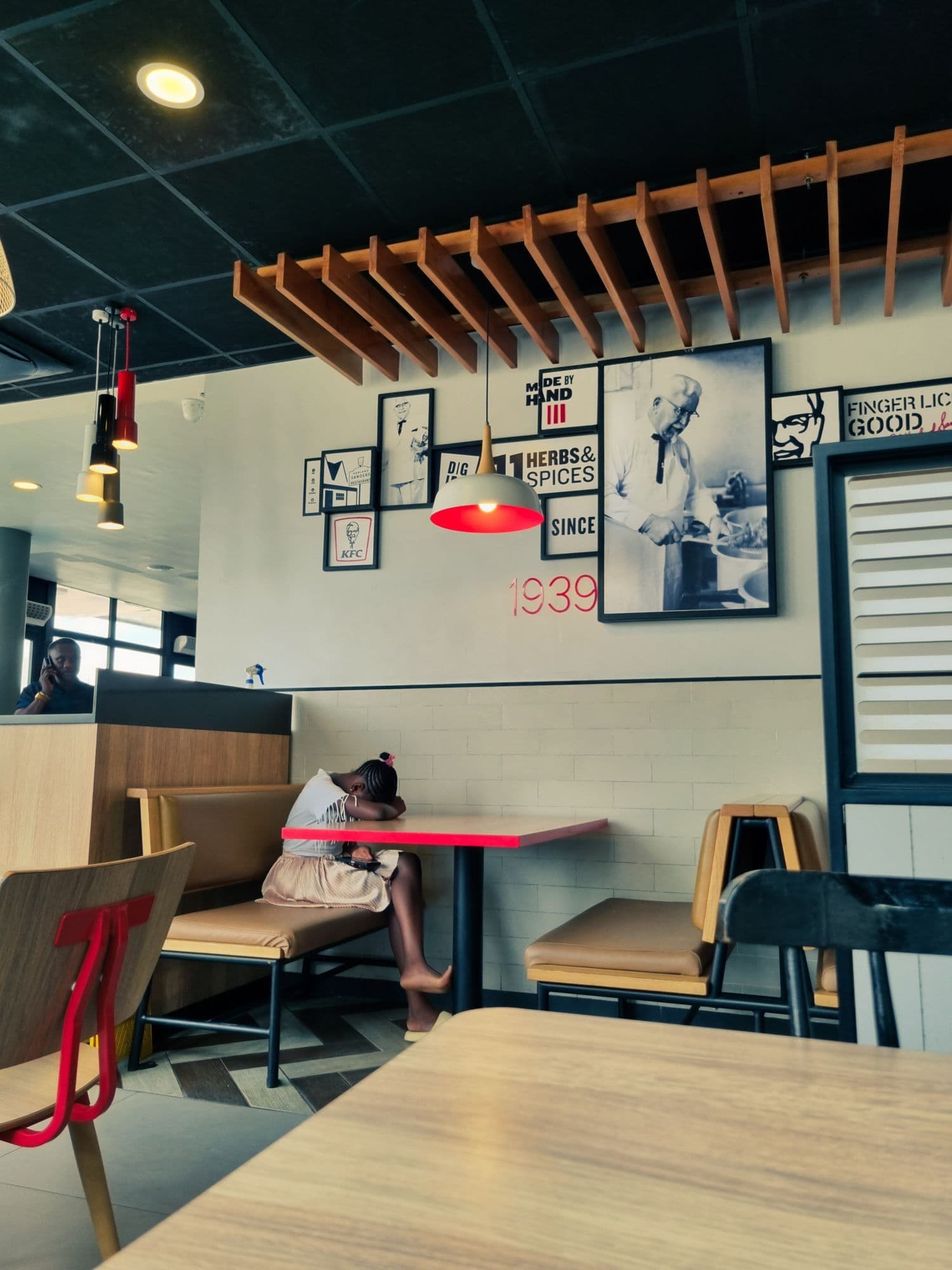 Person resting at a cafe table