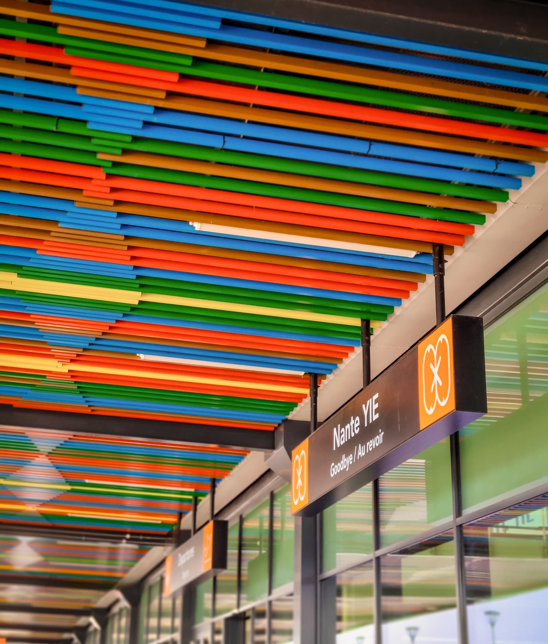 Colorful striped ceiling in an airport with a departures sign