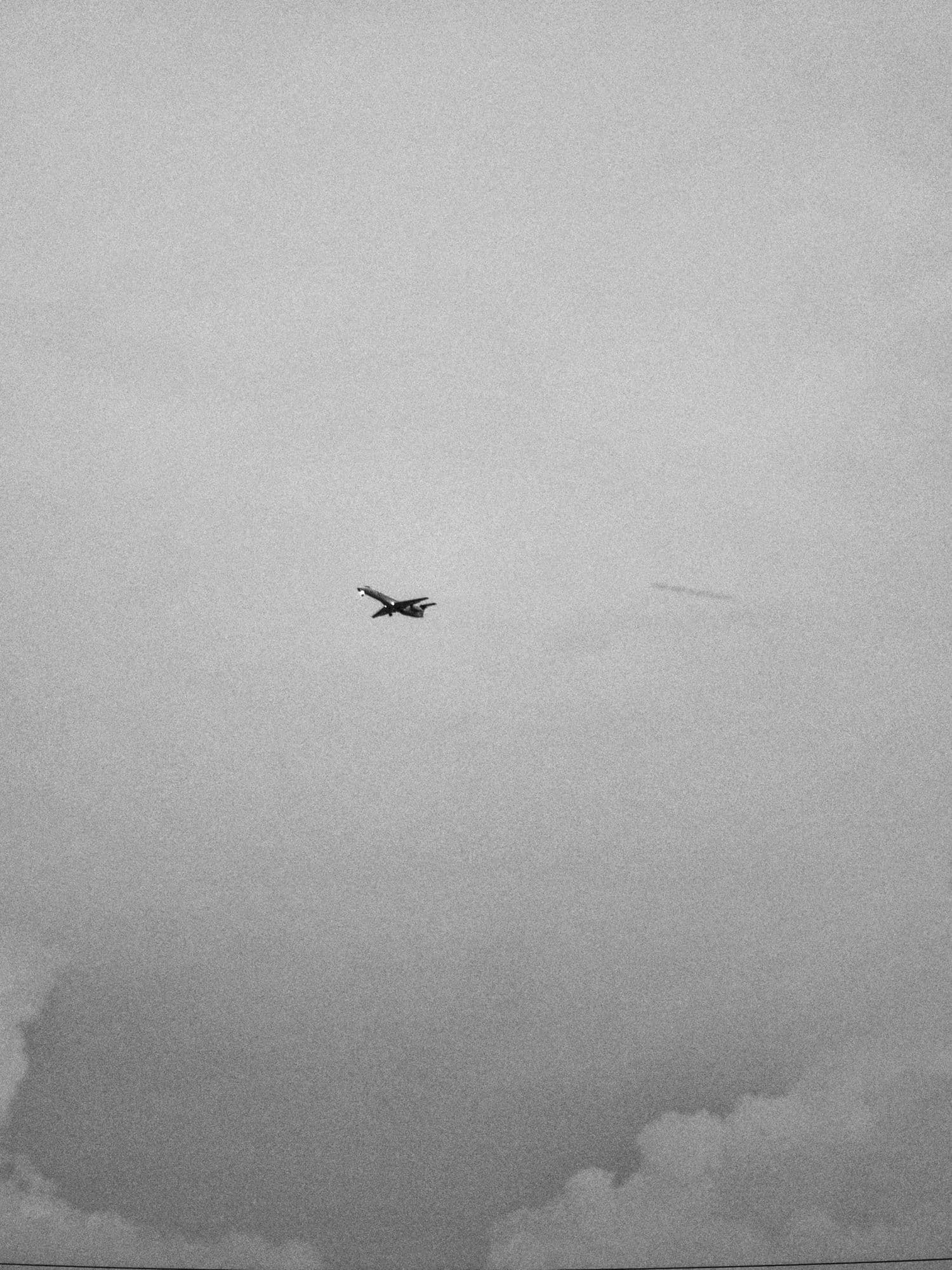 Airplane in flight against a cloudy sky