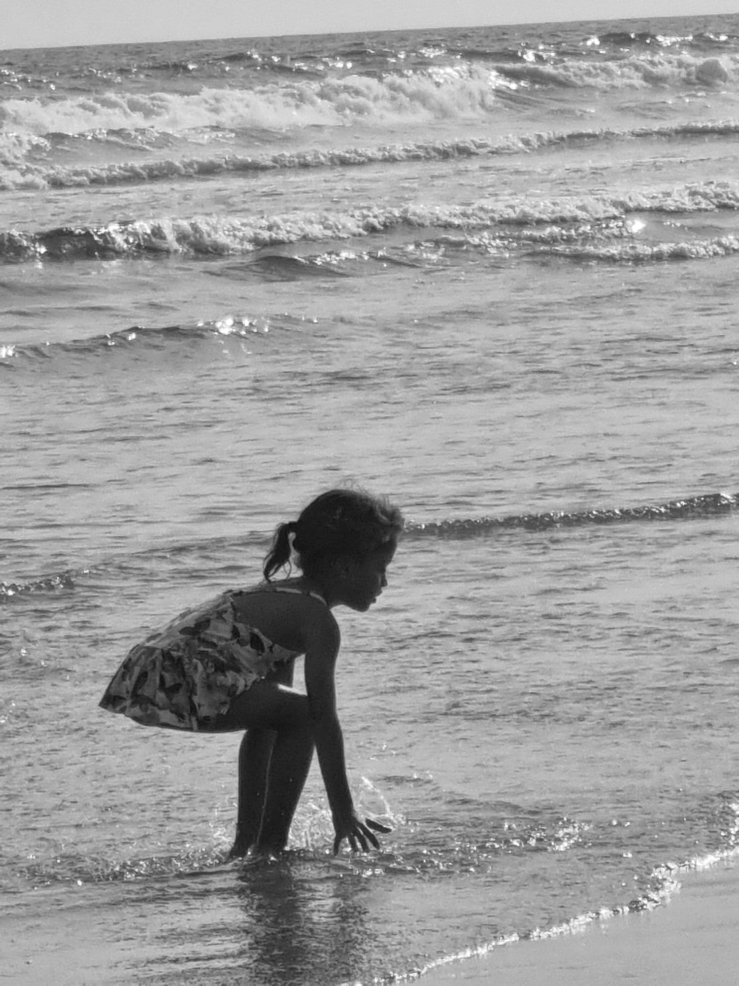 Child playing in the ocean surf