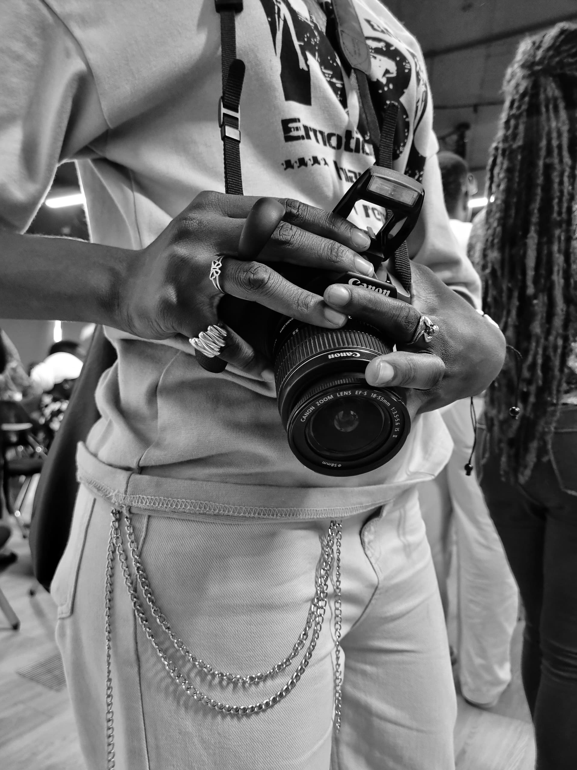 Close-up of hands holding a Canon camera