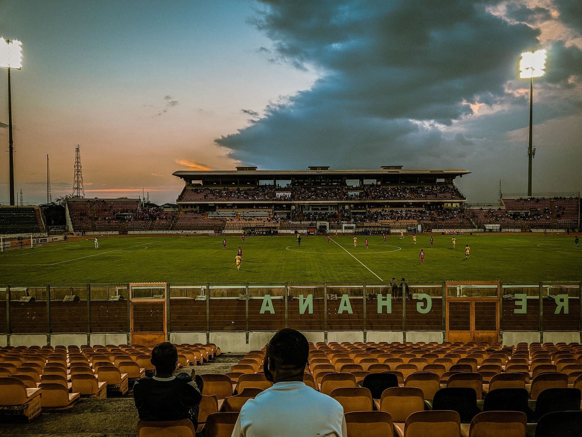 Stadium with players at sunset