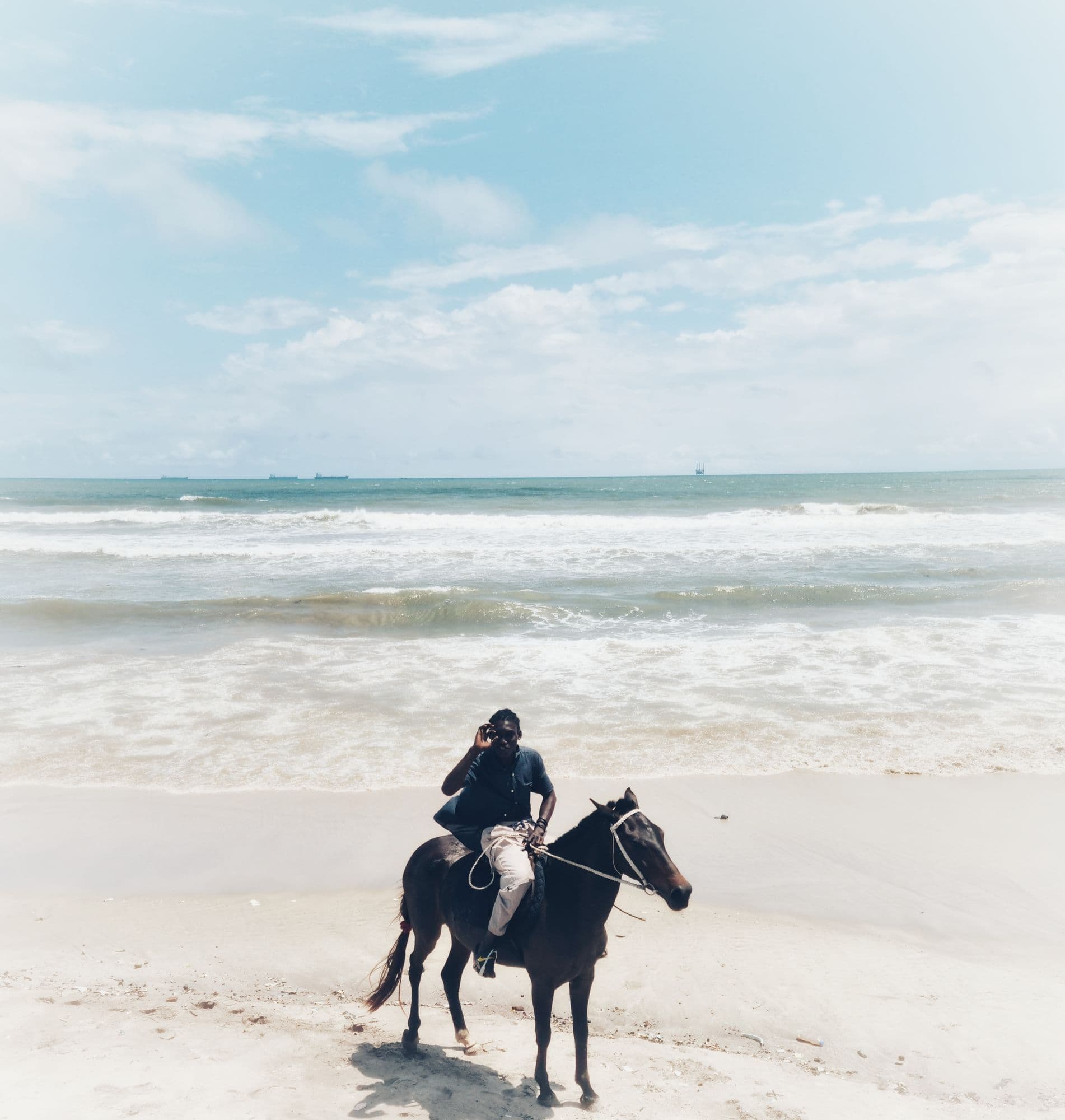 Person on a horse at the beach